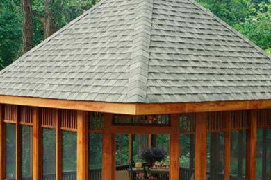 Inspiration for a large transitional backyard stone patio remodel in New York with a gazebo
