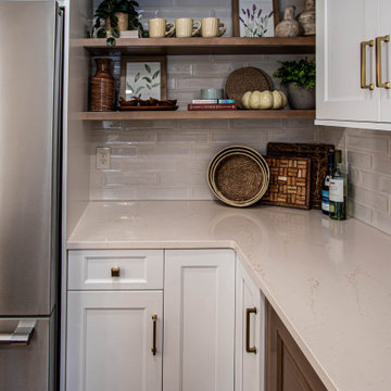 Two Tone Kitchen with Floating Shelves and Island Seating and Updated Fireplace