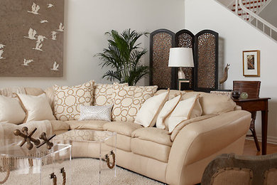 Example of a mid-sized classic open concept light wood floor living room design in Jacksonville with beige walls and a media wall
