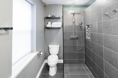 Example of a small minimalist master gray tile and ceramic tile ceramic tile walk-in shower design in Baltimore with a two-piece toilet and gray walls