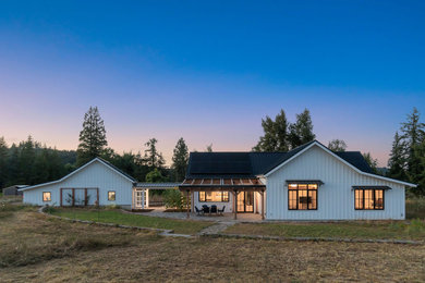 Farmhouse white one-story concrete fiberboard and board and batten exterior home photo in Portland with a metal roof