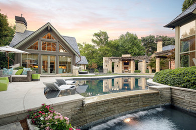 Example of a large classic two-story house exterior design in Dallas with a hip roof and a tile roof