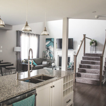 View of the great room open to above and staircase to the second floor from the