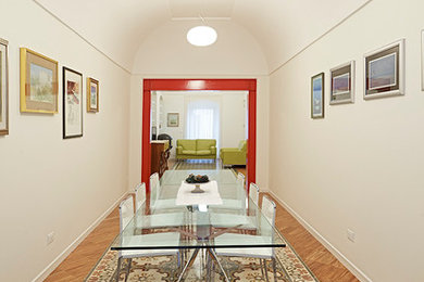Inspiration for a large mediterranean open plan dining in Bari with white walls and medium hardwood floors.