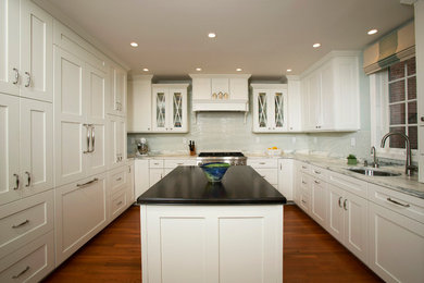 Photo of a traditional eat-in kitchen in DC Metro with panelled appliances, white cabinets, marble benchtops and shaker cabinets.
