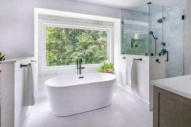 Inspiration for a mid-sized transitional master white tile and marble tile ceramic tile, white floor and double-sink bathroom remodel in Baltimore with furniture-like cabinets, medium tone wood cabinets, a two-piece toilet, white walls, an undermount sink, quartz countertops, a hinged shower door, white countertops, a niche and a freestanding vanity
