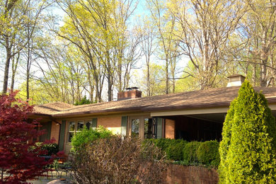 Inspiration for a large transitional red one-story brick house exterior remodel in Richmond with a hip roof and a shingle roof