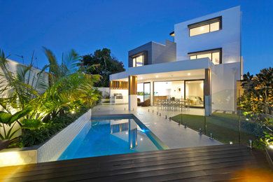Large contemporary three-storey concrete white house exterior in Gold Coast - Tweed with a flat roof and a metal roof.