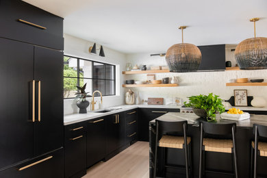 Trendy kitchen photo in Nashville with flat-panel cabinets, brick backsplash and stainless steel appliances