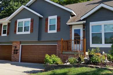 Large elegant blue two-story concrete fiberboard exterior home photo in Kansas City with a shingle roof