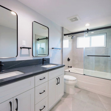Modern White Shaker Eco-Friendly Bathroom Remodel with Black Quartz Countertop