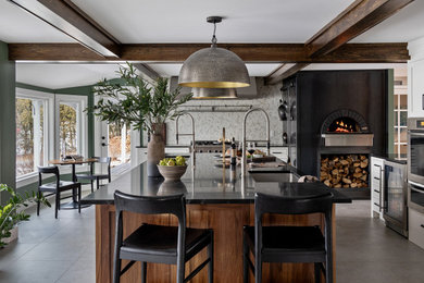 Eat-in kitchen - large transitional l-shaped ceramic tile, gray floor and exposed beam eat-in kitchen idea in Burlington with an undermount sink, shaker cabinets, dark wood cabinets, granite countertops, white backsplash, ceramic backsplash, stainless steel appliances, an island and black countertops