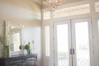 Example of a mid-sized trendy dark wood floor and brown floor entryway design in Other with gray walls and a glass front door