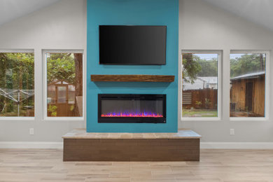 Inspiration for a mid-sized timeless formal porcelain tile, brown floor and vaulted ceiling living room remodel in Dallas with a standard fireplace, a stone fireplace, gray walls and a wall-mounted tv