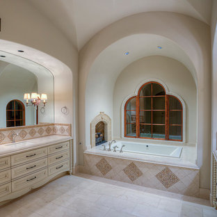 Huge tuscan master white tile and mosaic tile travertine floor bathroom photo in Phoenix with furniture-like cabinets, beige cabinets, a one-piece toilet, white walls, an integrated sink and granite countertops