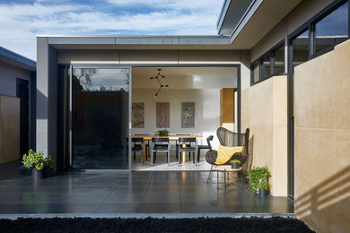 Design ideas for a mid-sized contemporary home design in Melbourne.