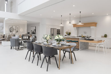 Design ideas for an expansive l-shaped open plan kitchen with a double-bowl sink, marble benchtops, coloured appliances, porcelain floors and with island.