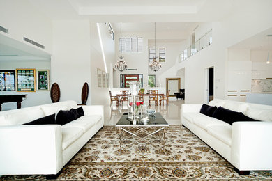 This is an example of an expansive contemporary open concept living room in Brisbane with white walls and no tv.