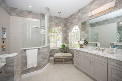 This is an example of a medium sized traditional ensuite bathroom in Tampa with grey cabinets, a corner shower, a one-piece toilet, grey walls, a built-in sink, grey floors, an open shower, white worktops, an enclosed toilet, a single sink, a built in vanity unit and wallpapered walls.