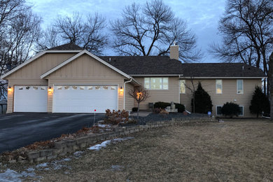 Inspiration for a mid-sized timeless one-story mixed siding house exterior remodel in Minneapolis with a clipped gable roof and a shingle roof