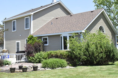 Example of a classic beige two-story house exterior design in Chicago