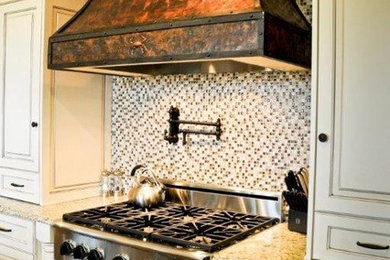 Inspiration for a small eclectic u-shaped medium tone wood floor open concept kitchen remodel in Charleston with recessed-panel cabinets, white cabinets, granite countertops, multicolored backsplash, glass tile backsplash, stainless steel appliances, an island and an undermount sink