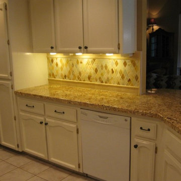 Juparana Granite counter-top with a rhomboid onyx back-splash