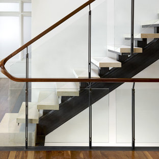 Urban straight glass railing staircase in San Francisco with open risers and limestone treads.
