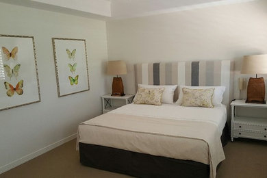 Design ideas for a mid-sized traditional master bedroom in Sunshine Coast with carpet, beige floor and white walls.