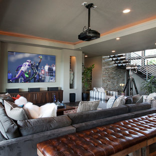 Home theater - large contemporary open concept black floor home theater idea in Portland with a projector screen and gray walls
