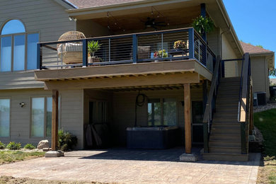 Deck - mid-sized craftsman backyard second story cable railing deck idea in Omaha with no cover