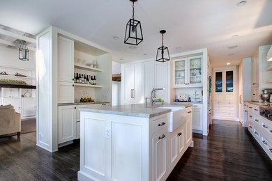 Mid-sized trendy medium tone wood floor kitchen photo in Chicago with a farmhouse sink, flat-panel cabinets, white cabinets, quartzite countertops and an island