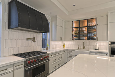 Inspiration for a large contemporary u-shaped porcelain tile, brown floor and vaulted ceiling enclosed kitchen remodel in New York with a farmhouse sink, recessed-panel cabinets, white cabinets, quartz countertops, white backsplash, porcelain backsplash, stainless steel appliances, an island and yellow countertops