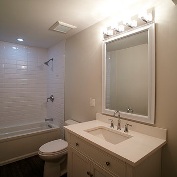Modern Bathroom with White Subway Tile, Sleek Vanity, and Bright Lighting