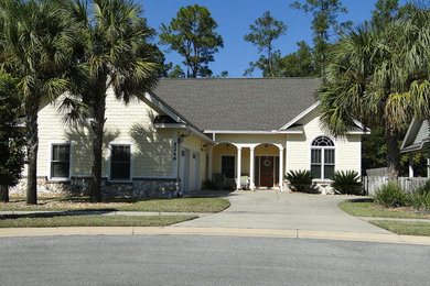 Inspiration for a mid-sized transitional yellow one-story brick exterior home remodel in Miami