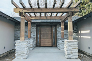 Mid-sized 1950s gray one-story stucco house exterior photo in Boise with a hip roof and a shingle roof