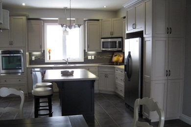 Eat-in kitchen - mid-sized traditional l-shaped ceramic tile and gray floor eat-in kitchen idea in Toronto with a double-bowl sink, shaker cabinets, white cabinets, granite countertops, gray backsplash, ceramic backsplash, stainless steel appliances and an island