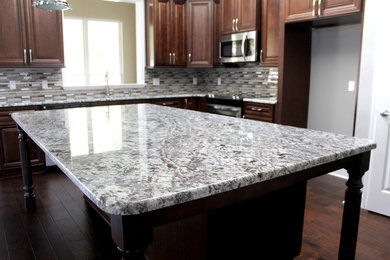Trendy kitchen photo in Miami with stainless steel appliances and an island