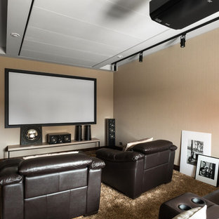 Photo of a contemporary enclosed home cinema in Saint Petersburg with beige walls, carpet, a projector screen and beige floors.