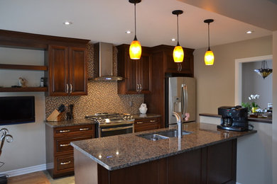 Example of a l-shaped medium tone wood floor open concept kitchen design in Ottawa with an undermount sink, shaker cabinets, dark wood cabinets, granite countertops, multicolored backsplash, matchstick tile backsplash, stainless steel appliances and an island