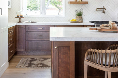 Example of a large transitional galley medium tone wood floor and beige floor open concept kitchen design in Sacramento with a farmhouse sink, shaker cabinets, medium tone wood cabinets, marble countertops, white backsplash, terra-cotta backsplash, colored appliances, an island and yellow countertops
