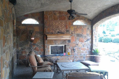 Inspiration for a mediterranean backyard concrete paver patio remodel in Other with a roof extension