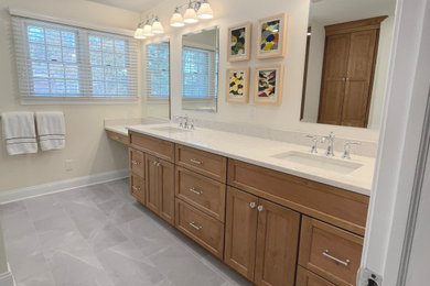 Inspiration for a large transitional master beige tile and subway tile porcelain tile, gray floor and double-sink sliding shower door remodel in Philadelphia with shaker cabinets, medium tone wood cabinets, a one-piece toilet, beige walls, an undermount sink, quartz countertops, white countertops, a niche and a built-in vanity