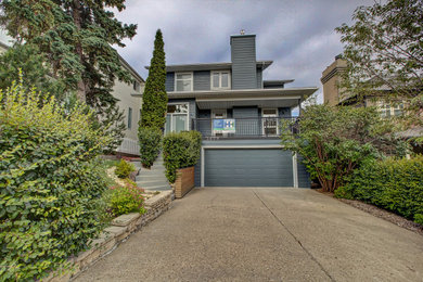 Example of a trendy blue concrete fiberboard house exterior design in Calgary