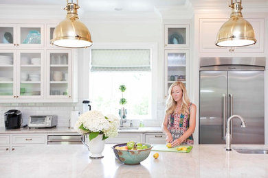 Elegant kitchen photo in Charlotte with glass-front cabinets and white cabinets