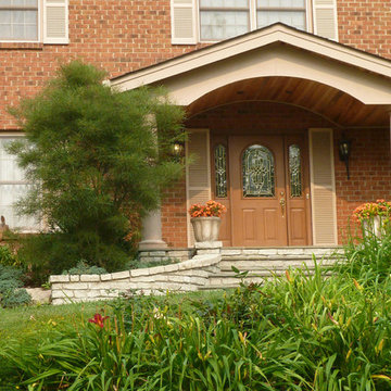Front Porch with Stone Steps and curved tongue and groove wood ceiling