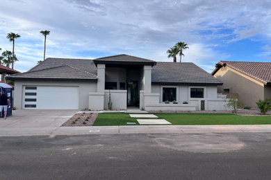 Mid-sized transitional beige one-story stucco house exterior photo in Phoenix with a brown roof