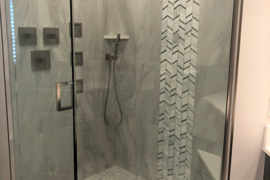 Design ideas for a contemporary master bathroom in Miami with a corner shower, gray tile, porcelain tile and a hinged shower door.