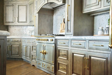 Kitchen - transitional medium tone wood floor and brown floor kitchen idea in Columbus with a farmhouse sink, marble countertops, white backsplash, marble backsplash, stainless steel appliances and an island