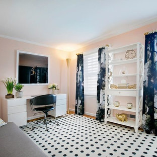 Mid-sized transitional study room in New York with pink walls, a freestanding desk and light hardwood floors.